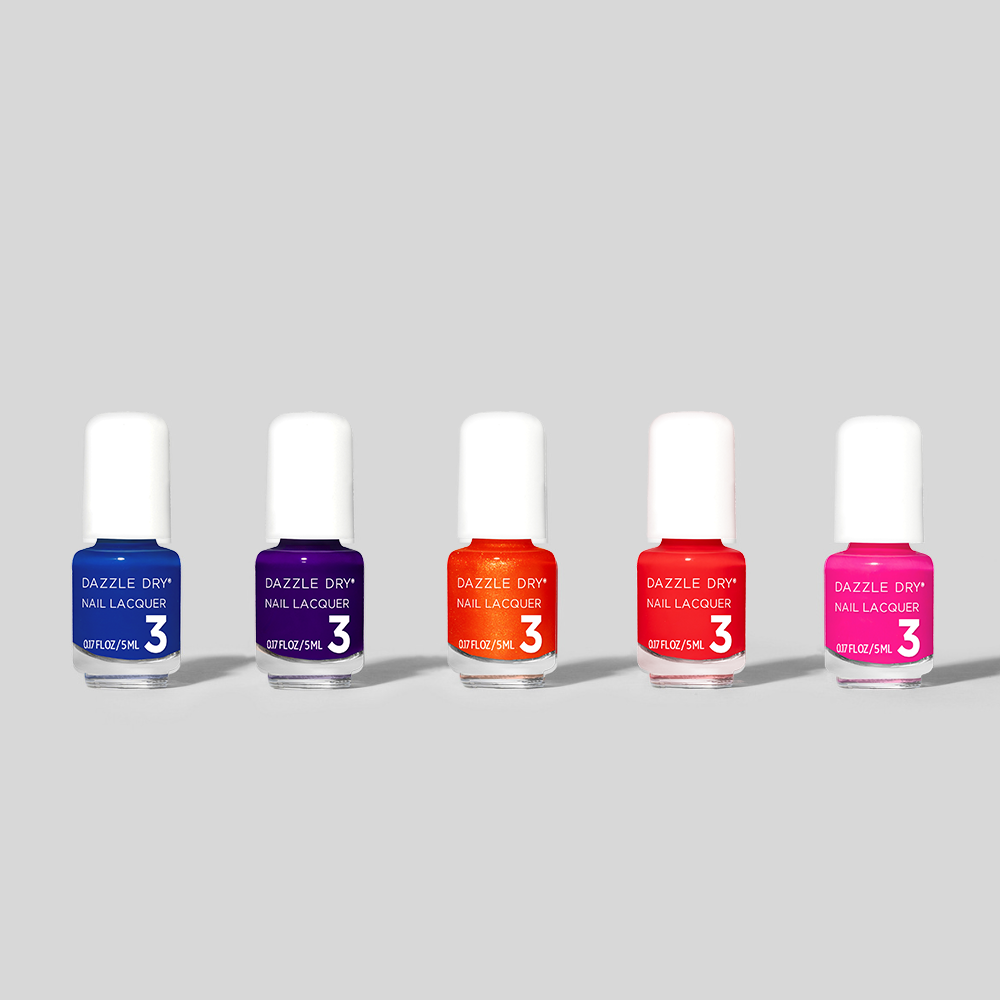 Five bottles of Dazzle Dry nail polish on a light gray background